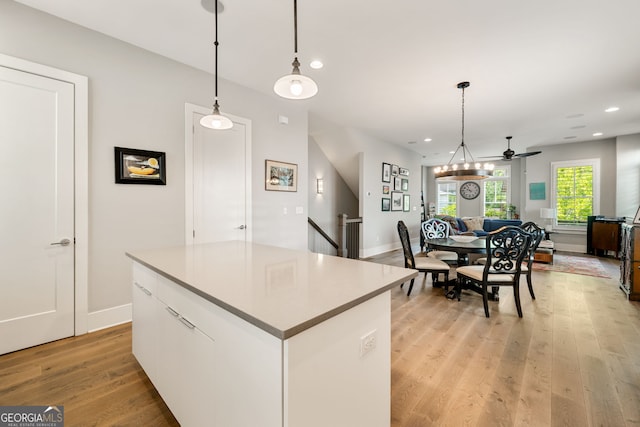 986 Mauldin St SE, Atlanta, GA 30316 - kitchen with light wood finished floors, a center island, white cabinetry, open floor plan, and recessed lighting