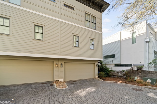 986 Mauldin St SE, Atlanta, GA 30316 - view of side of property with a garage and decorative driveway