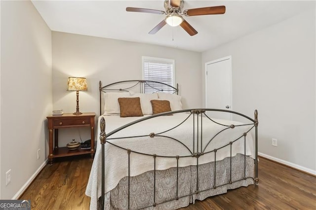 bedroom featuring baseboards and wood finished floors