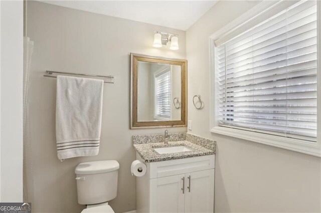 bathroom featuring toilet and vanity