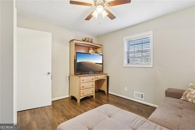 bedroom featuring baseboards, wood finished floors, visible vents, and ceiling fan