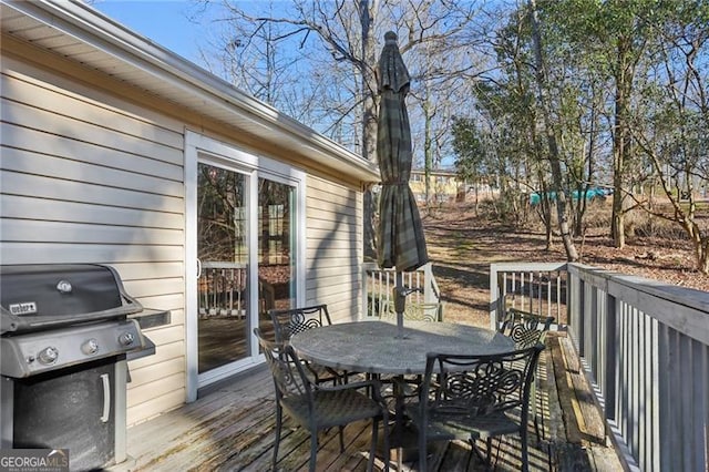 wooden deck featuring outdoor dining space and area for grilling