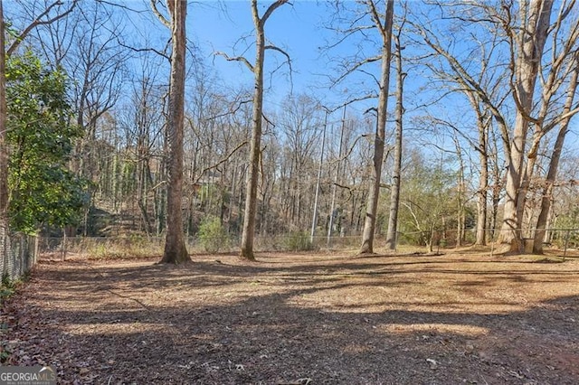 view of landscape featuring a forest view