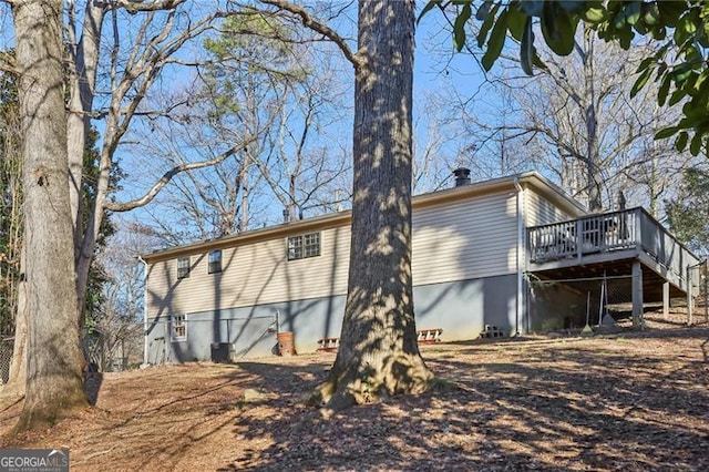 rear view of house with stairs and a deck
