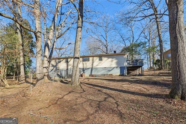 exterior space featuring a wooden deck and fence