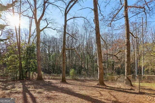 view of landscape featuring a wooded view