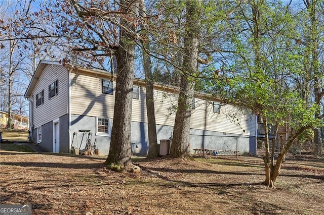 view of property exterior with fence