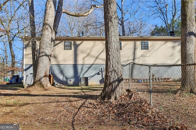 view of side of home featuring fence