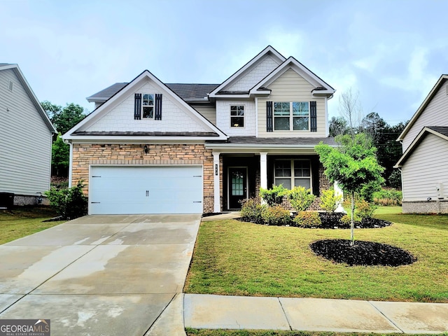 craftsman-style house featuring a garage, stone siding, a front lawn, and concrete driveway