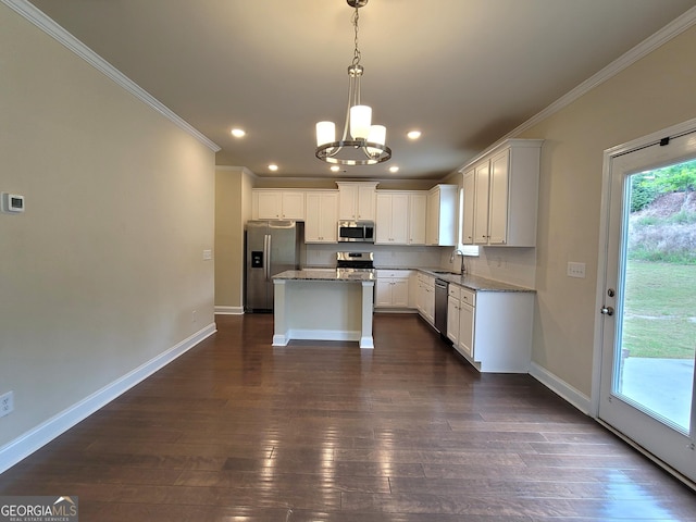 kitchen with a notable chandelier, baseboards, crown molding, and stainless steel appliances
