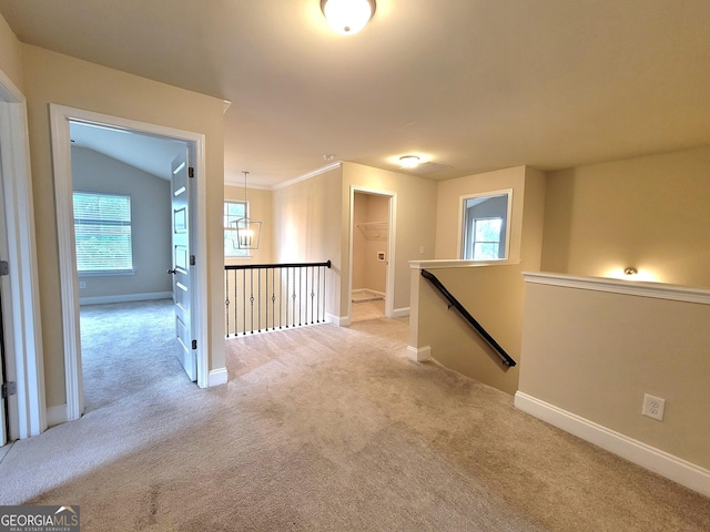 hall featuring baseboards, an upstairs landing, and light colored carpet