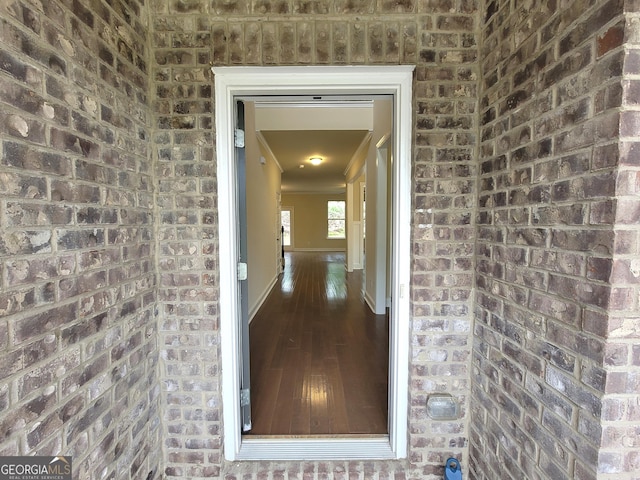 view of exterior entry featuring brick siding