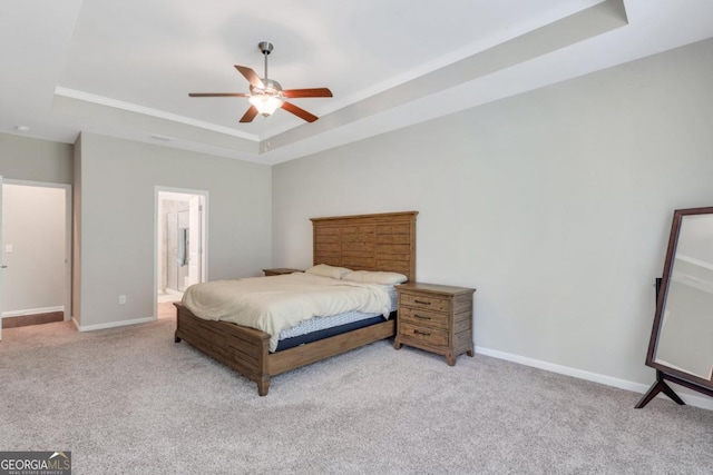 128 Clearwater Dr, Brunswick, GA 31523 - bedroom with baseboards, ceiling fan, ensuite bath, carpet floors, and a raised ceiling
