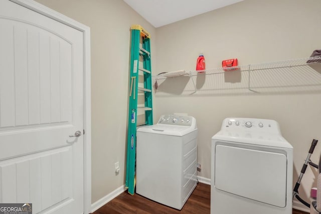 128 Clearwater Dr, Brunswick, GA 31523 - washroom with washing machine and dryer, baseboards, dark wood-type flooring, and laundry area