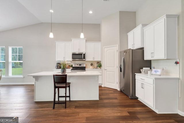 128 Clearwater Dr, Brunswick, GA 31523 - kitchen featuring high vaulted ceiling, appliances with stainless steel finishes, white cabinetry, and light countertops