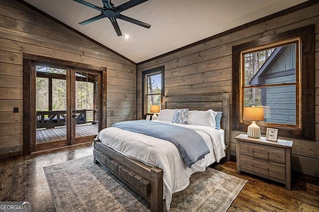 bedroom with wood walls, dark wood-style floors, vaulted ceiling, french doors, and access to outside