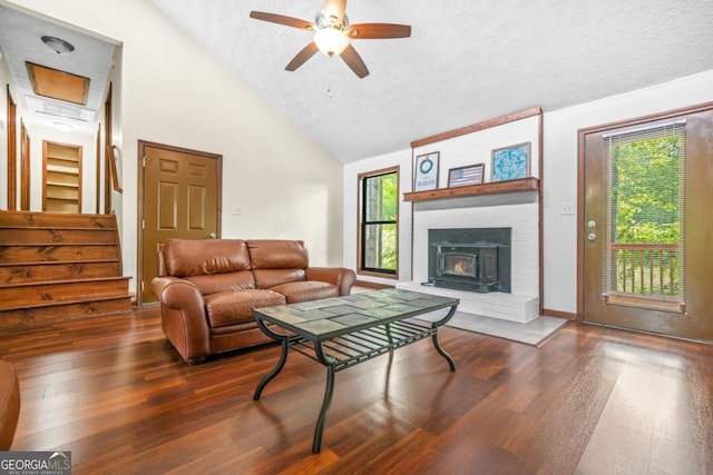 living area with plenty of natural light, wood finished floors, and a fireplace