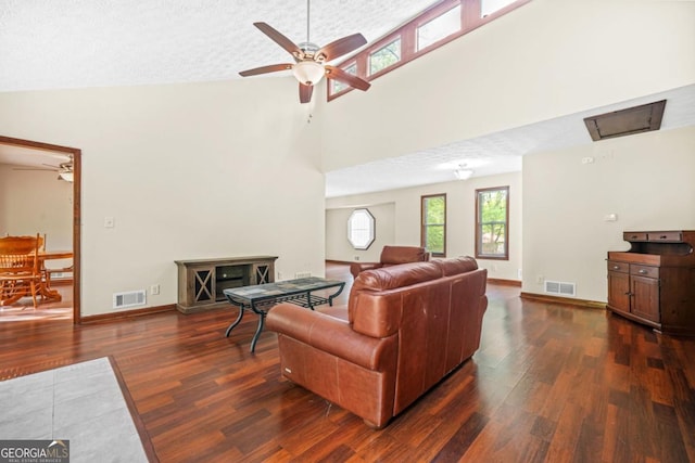 living room with ceiling fan, dark wood-style floors, and visible vents