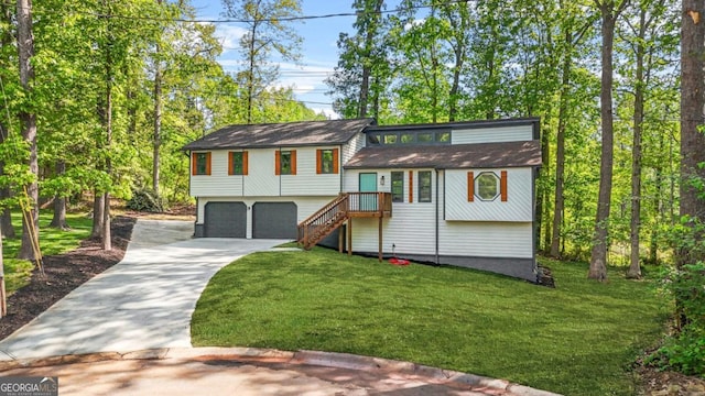 view of front of house with an attached garage, driveway, and a front lawn