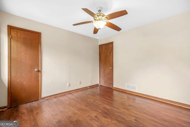 unfurnished room with visible vents, baseboards, wood finished floors, and ceiling fan