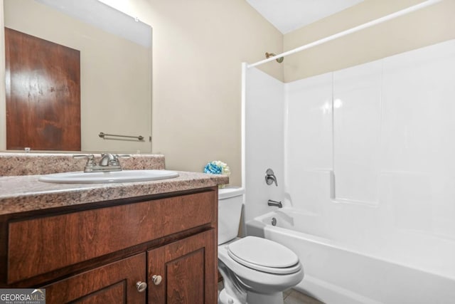 bathroom featuring vanity, washtub / shower combination, and toilet