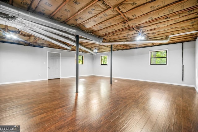 below grade area with wood finished floors and baseboards
