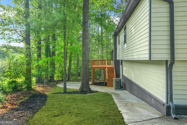view of yard with stairway and central AC unit