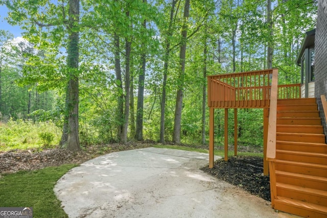 view of patio featuring a wooden deck and stairway