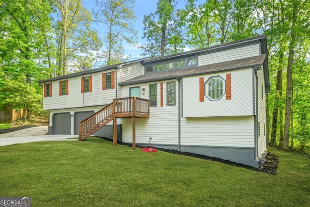 view of front of property with concrete driveway, an attached garage, stairs, and a front lawn