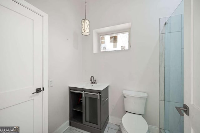 full bathroom featuring toilet, walk in shower, vanity, and baseboards