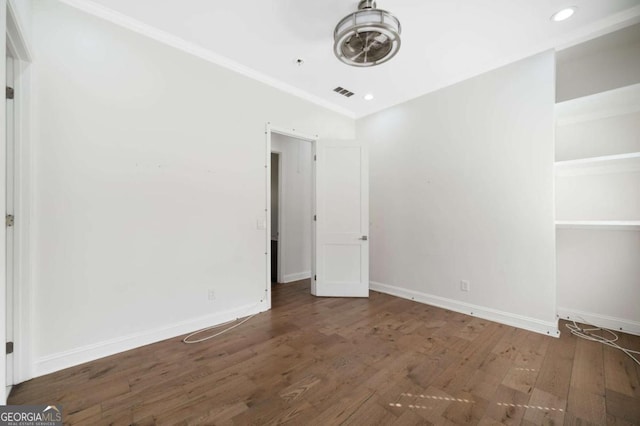 unfurnished bedroom with crown molding, wood finished floors, baseboards, visible vents, and recessed lighting