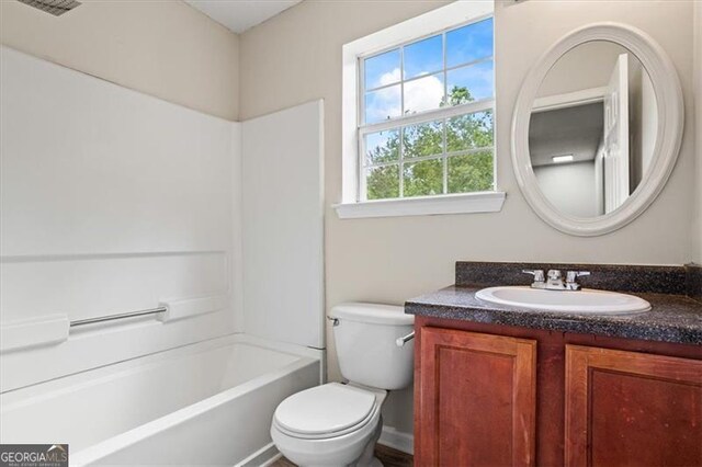 full bathroom with bathtub / shower combination, vanity, and toilet