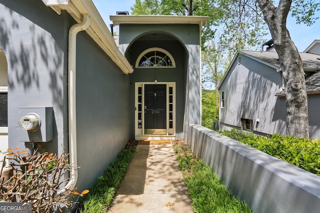 doorway to property with stucco siding