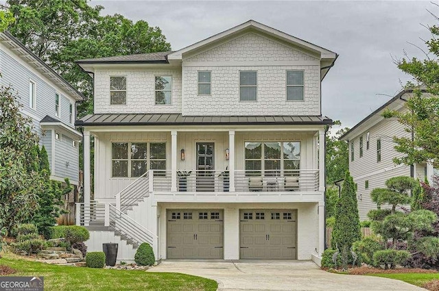 1059 Antioch Dr, Brookhaven, GA 30319 - view of front of house with a standing seam roof, stairs, an attached garage, and concrete driveway