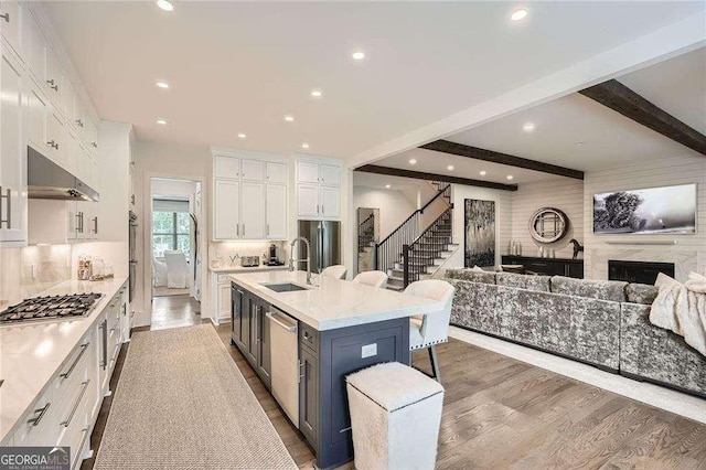 1059 Antioch Dr, Brookhaven, GA 30319 - kitchen with appliances with stainless steel finishes, a sink, light countertops, white cabinets, and open floor plan