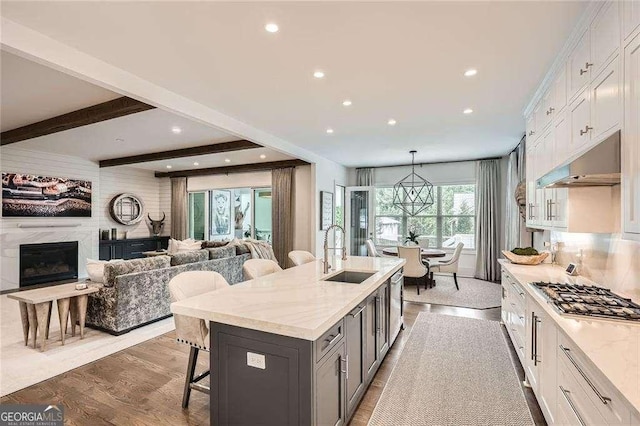 1059 Antioch Dr, Brookhaven, GA 30319 - kitchen featuring a kitchen bar, appliances with stainless steel finishes, a sink, open floor plan, and extractor fan