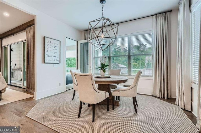 1059 Antioch Dr, Brookhaven, GA 30319 - dining space featuring baseboards, wood finished floors, and a chandelier