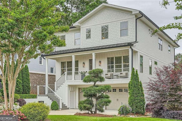 1059 Antioch Dr, Brookhaven, GA 30319 - view of front facade with an attached garage, board and batten siding, a porch, stairway, and a standing seam roof