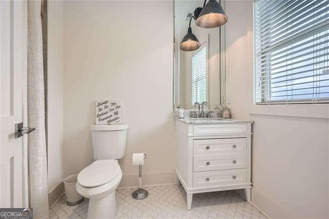 1059 Antioch Dr, Brookhaven, GA 30319 - bathroom featuring toilet, baseboards, and vanity
