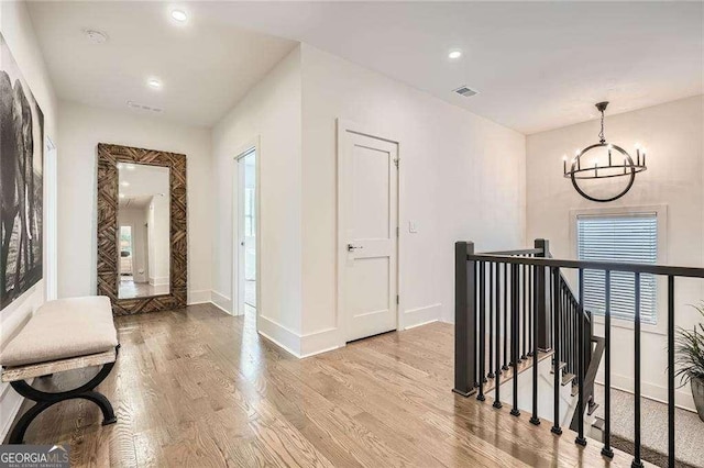 1059 Antioch Dr, Brookhaven, GA 30319 - hallway featuring visible vents, baseboards, wood finished floors, and an upstairs landing