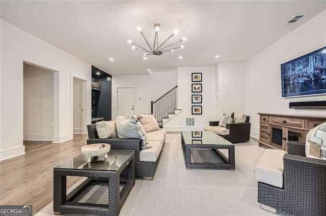 1059 Antioch Dr, Brookhaven, GA 30319 - living room with visible vents, wood finished floors, baseboards, an inviting chandelier, and stairs