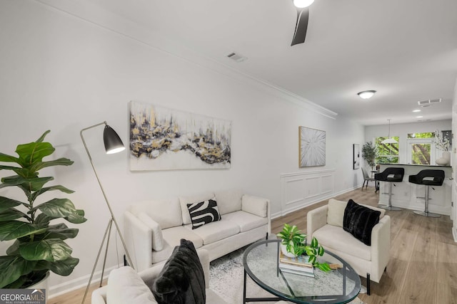 863 Commonwealth Ave SE, Atlanta, GA 30312 - living room featuring crown molding, light wood-style floors, and baseboards