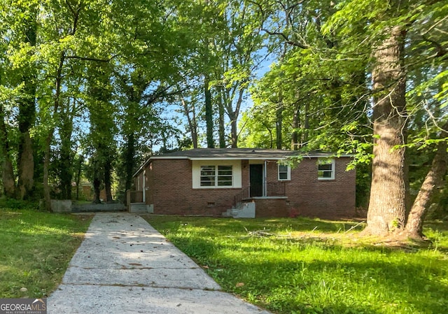 233 Banberry Dr SE, Atlanta, GA 30315 - view of front facade with concrete driveway, a front lawn, brick siding, and crawl space