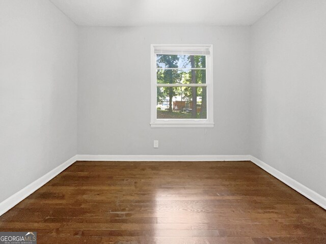 233 Banberry Dr SE, Atlanta, GA 30315 - spare room featuring baseboards and dark wood-style floors