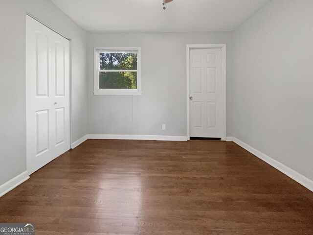 233 Banberry Dr SE, Atlanta, GA 30315 - unfurnished bedroom featuring baseboards and dark wood-type flooring