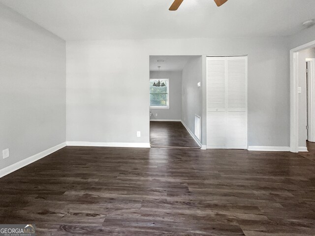 233 Banberry Dr SE, Atlanta, GA 30315 - unfurnished room featuring ceiling fan with notable chandelier, baseboards, and dark wood-type flooring