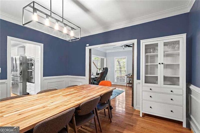 5729 Brookstone Walk NW, Acworth, GA 30101 - dining room with crown molding, wood finished floors, a wainscoted wall, and a decorative wall