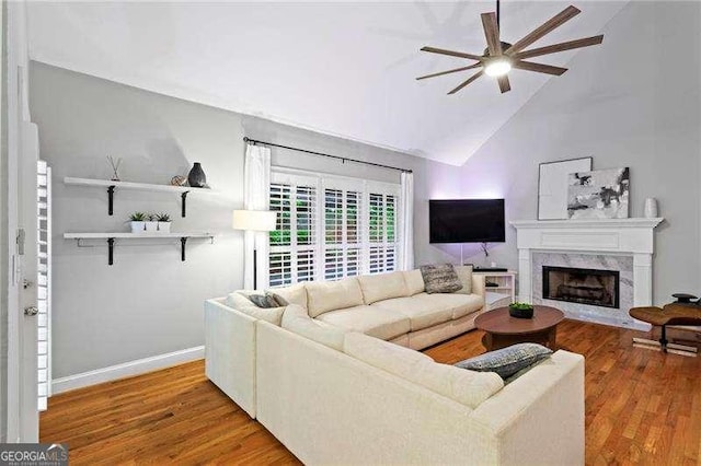 5729 Brookstone Walk NW, Acworth, GA 30101 - living area with ceiling fan, wood finished floors, a high end fireplace, baseboards, and high vaulted ceiling
