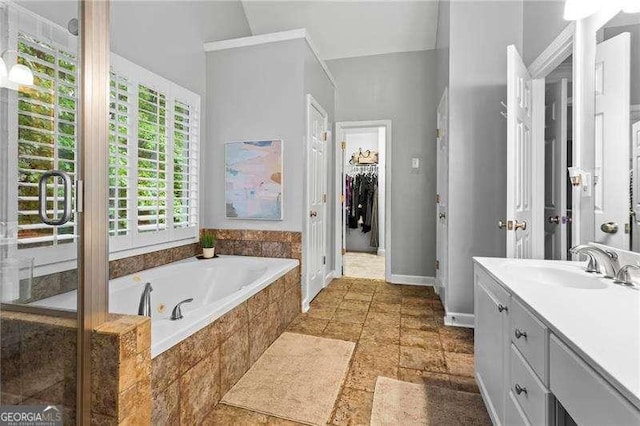 5729 Brookstone Walk NW, Acworth, GA 30101 - full bathroom featuring vanity, a bath, a spacious closet, and baseboards