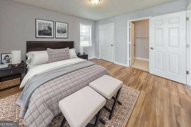 bedroom with baseboards and wood finished floors